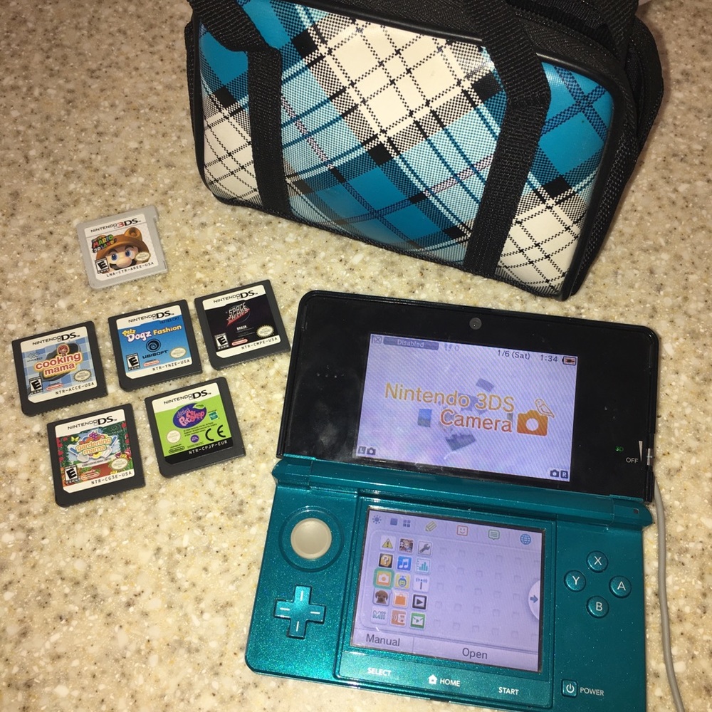 Nintendo 3ds with games, charger and carry case